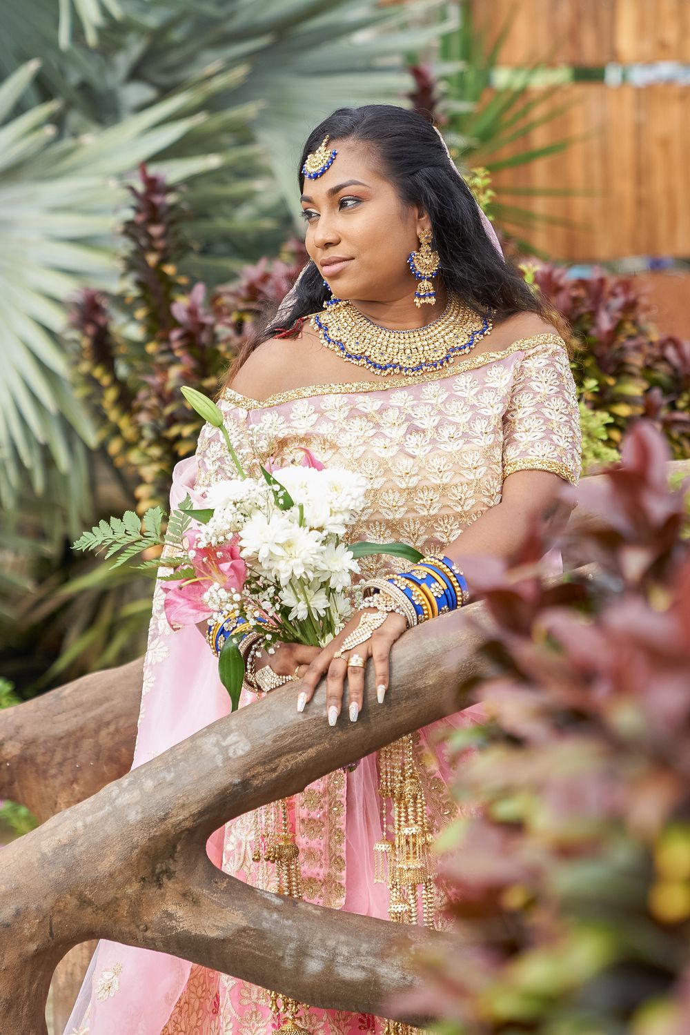 Bride in traditional pink and gold bridal wear