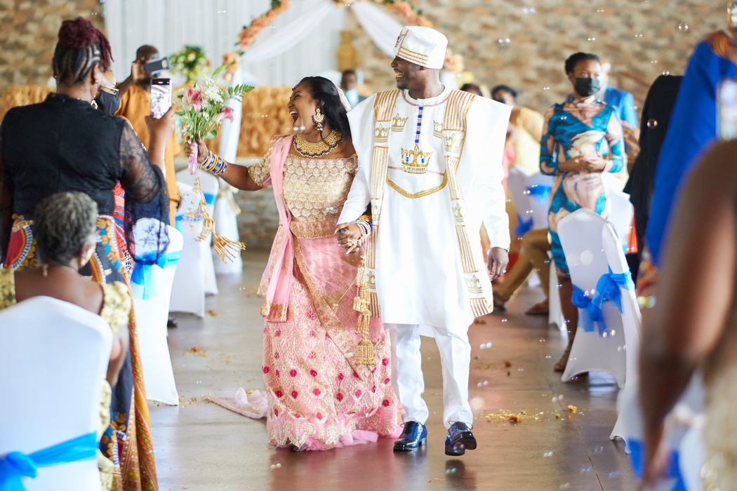 Newlyweds walking down the aisle in traditional wedding attire